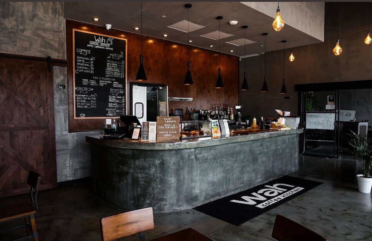 Concrete bar with chalkboard menu and pendant lights