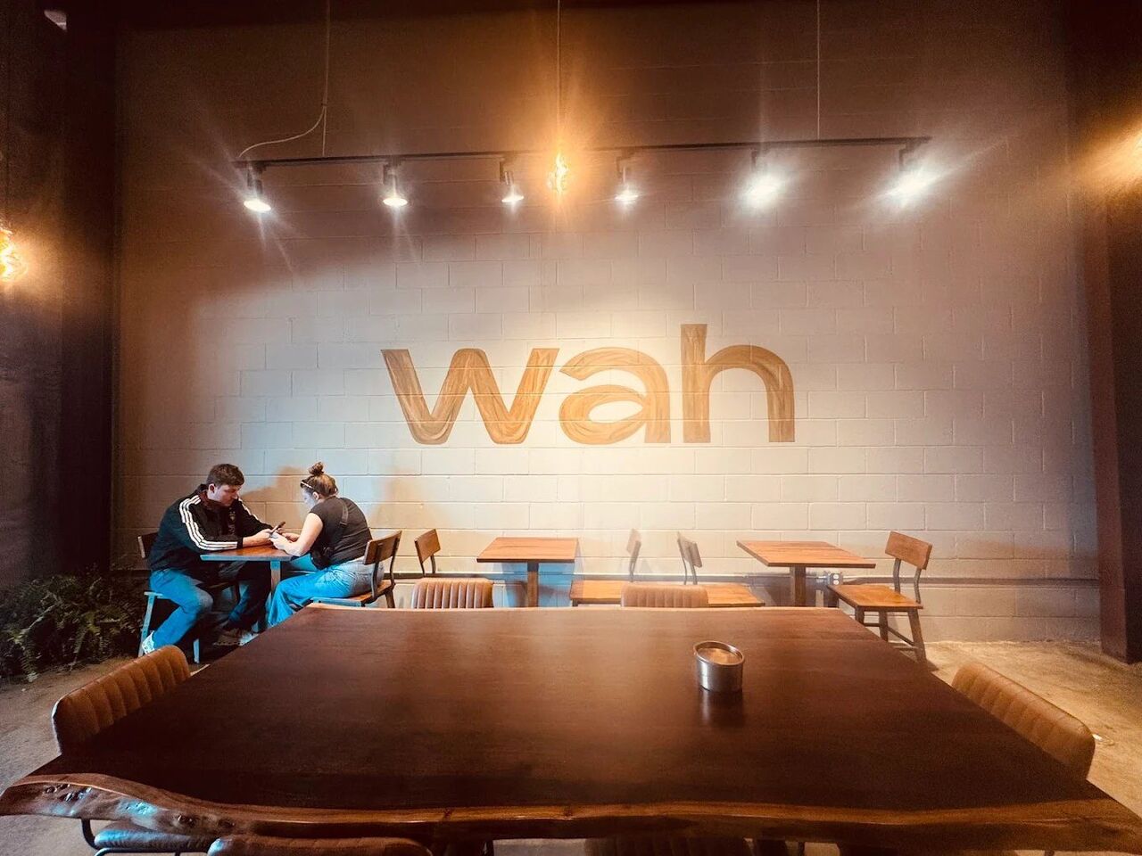 Wah mural with dining setup and pendant lighting