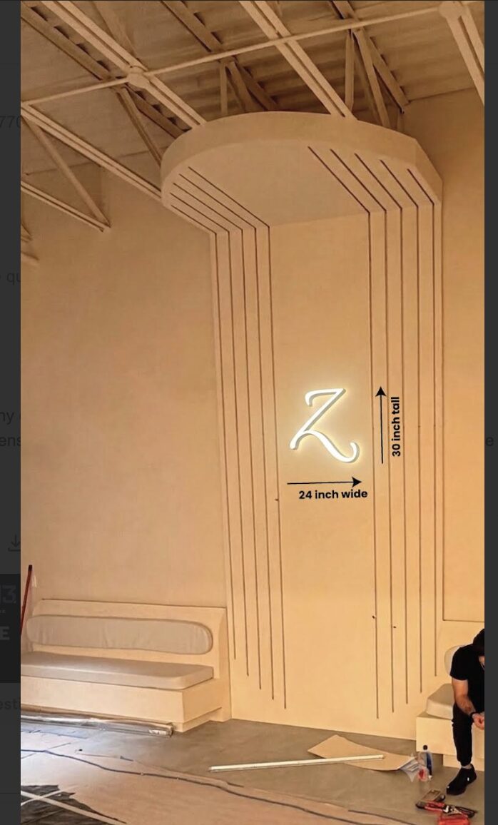 Backlit Z monogram sign detail with fluted ceiling feature
