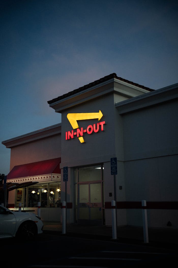 In-N-Out Burger fast food restaurant captured at twilight with distinct signage.